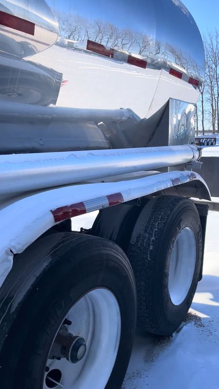 Snow-dusted fenders and tandem wheels beneath the polished tank.